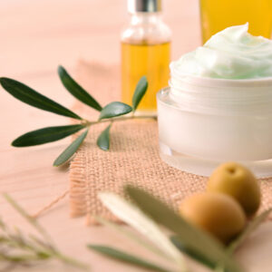 Olive moisturizing cream and serum for skin on wood elevated