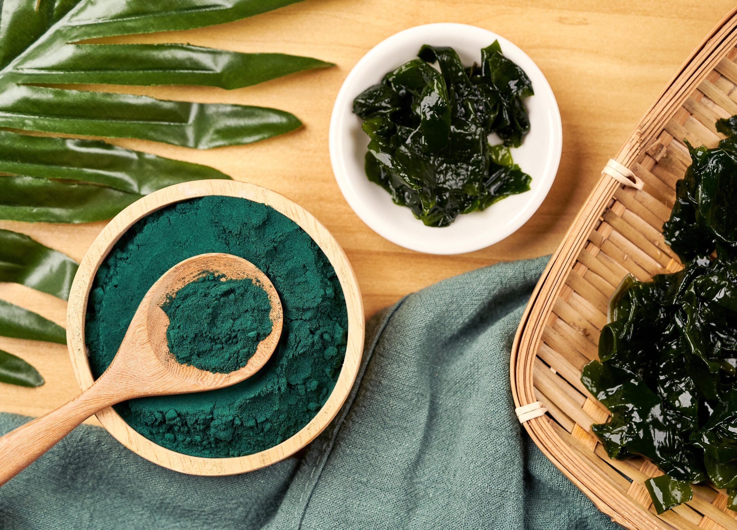 A IMAGES FOR COMPLETION_SPIRULINA CHOICE 2_stock-photo-top-view-laminaria-or-kelp-seaweed-and-spirulina-powder-in-wood-bowl-and-spoon-background-flat-lay-2036479103-min